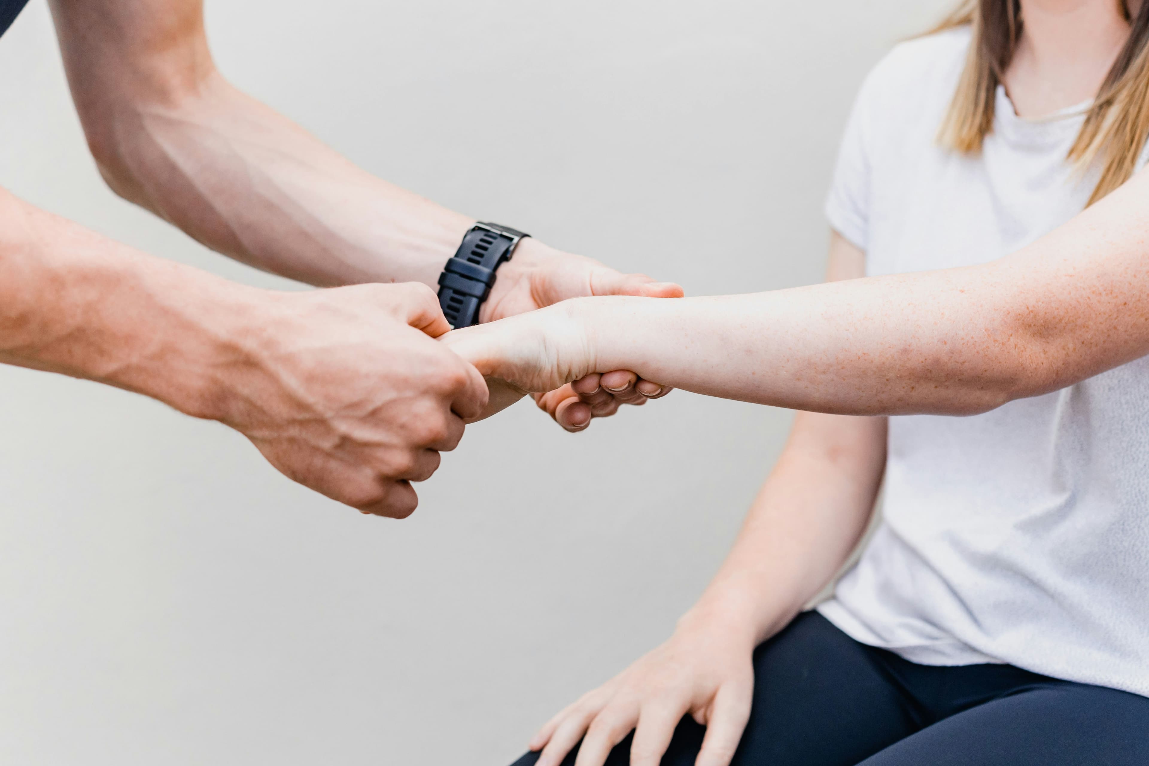 A physiotherapist assessing a patient’s wrist